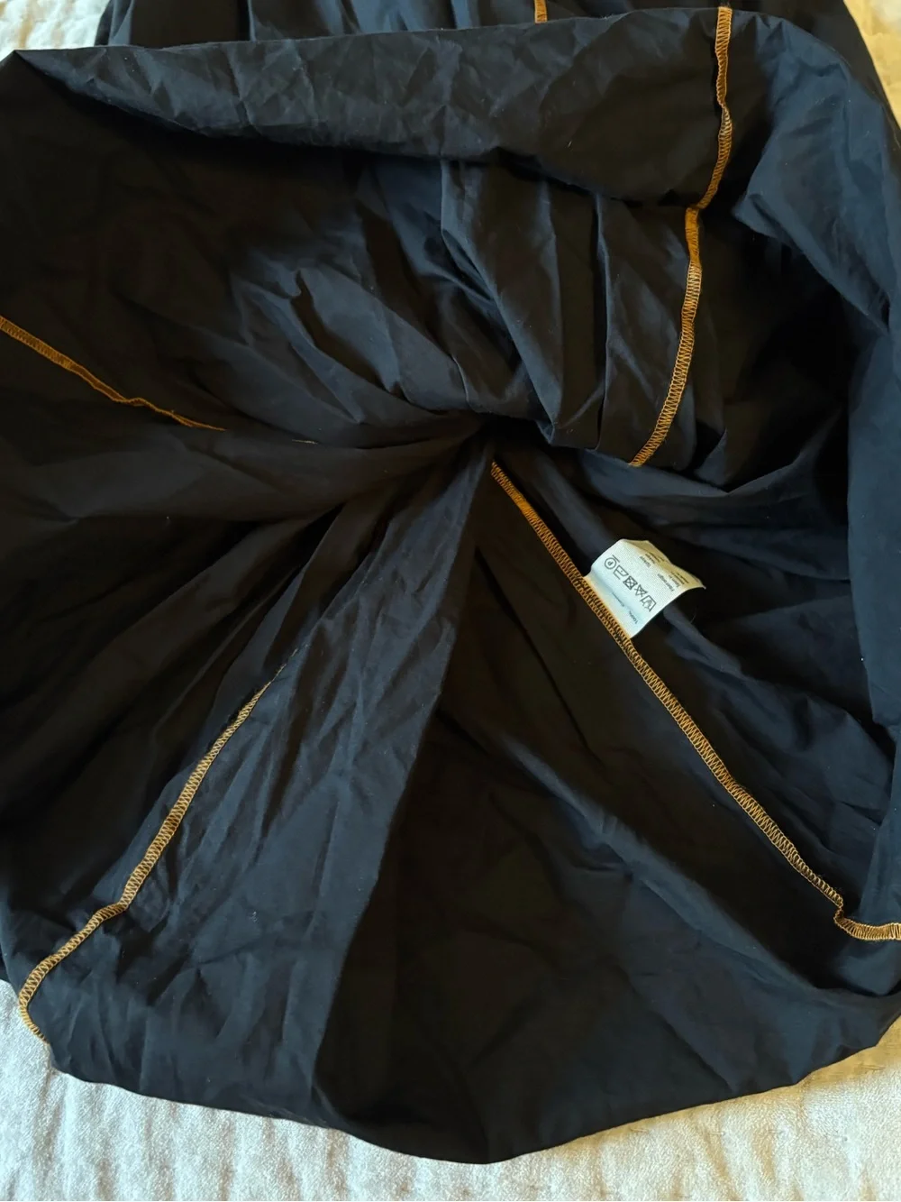 BASERANGE The Turn Skirt In Black Organic Cotton Contrast Stitch Twisted Seams